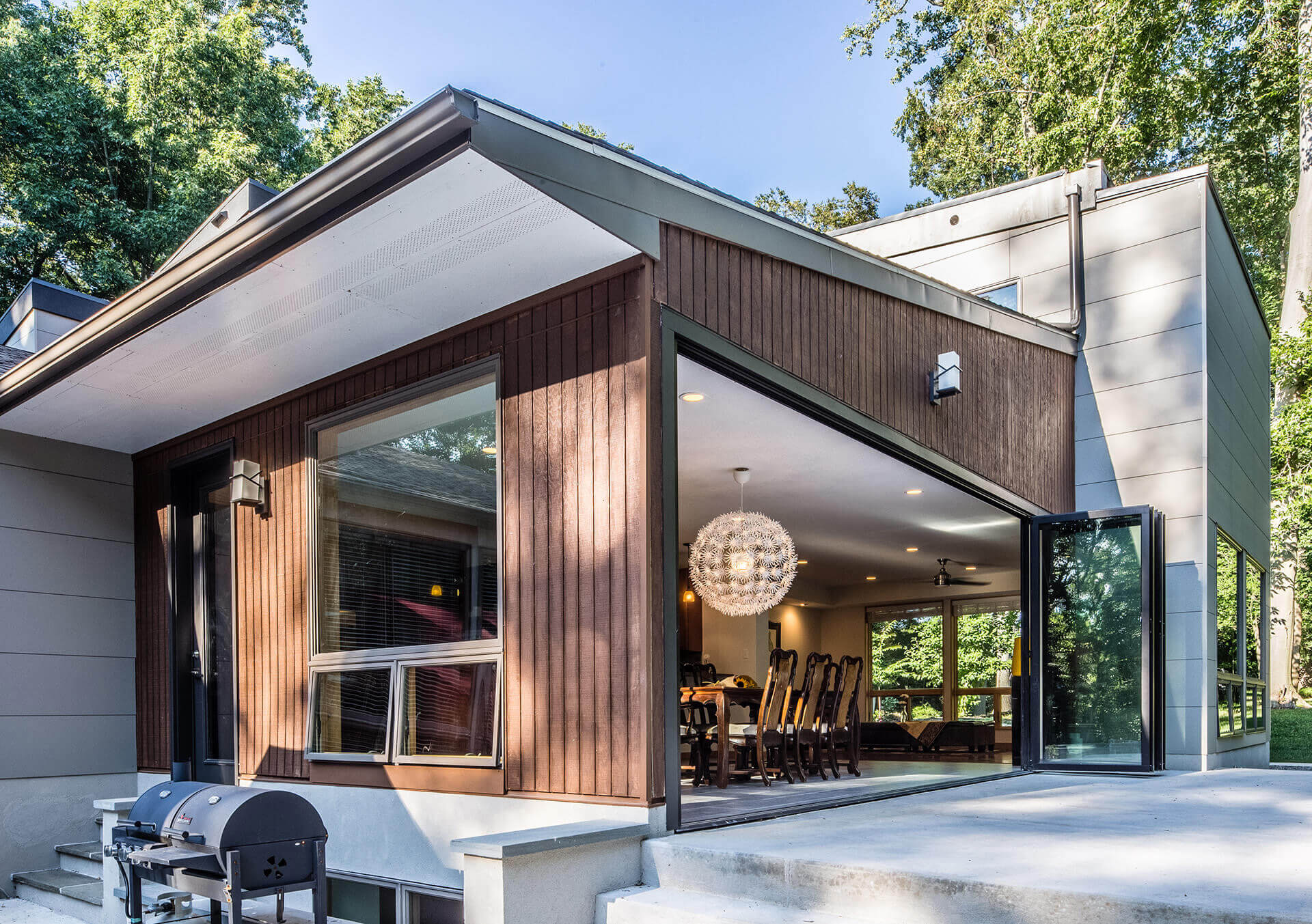 Modern home clad with weathered real wood and Nichiha’s ArchBlock panels in Gray