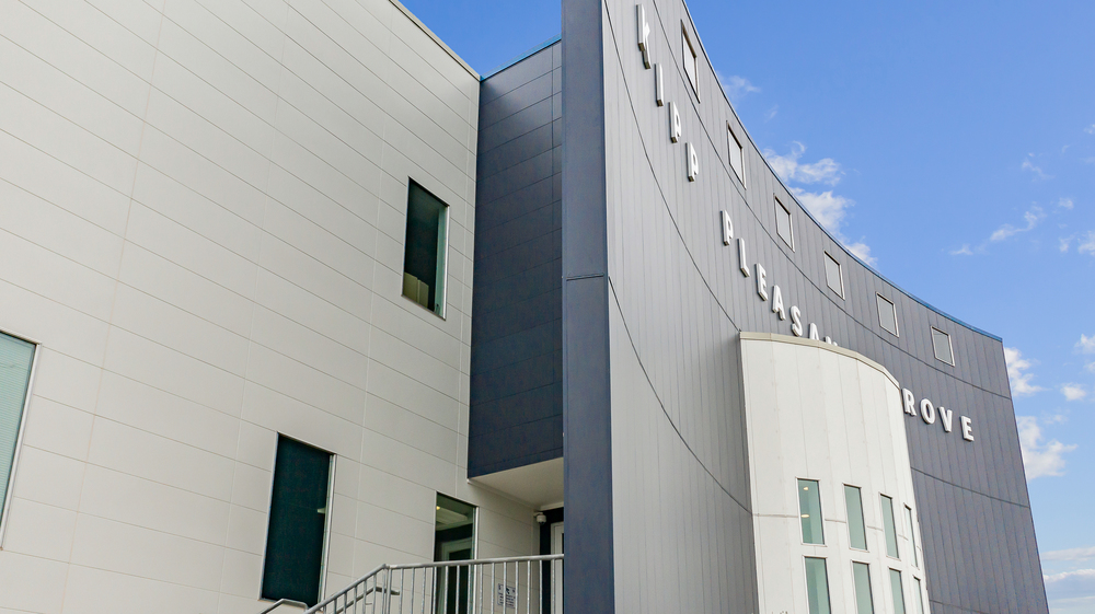 Kipp Pleasant Grove Middle School close-up of Nichiha’s fiber cement cladding from their Illumination series in blue and white.