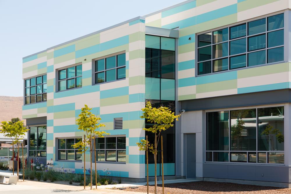 Tennyson High School with Nichiha’s Illumination panels in white, blue and green.