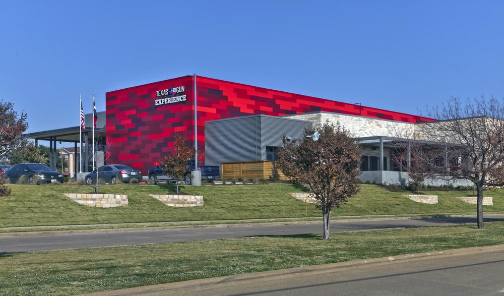This shooting range in Texas has red fiber cement siding on the exterior.