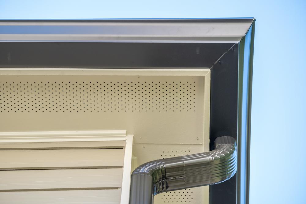 Close-up view of soffit vents with a gutter also pictured.