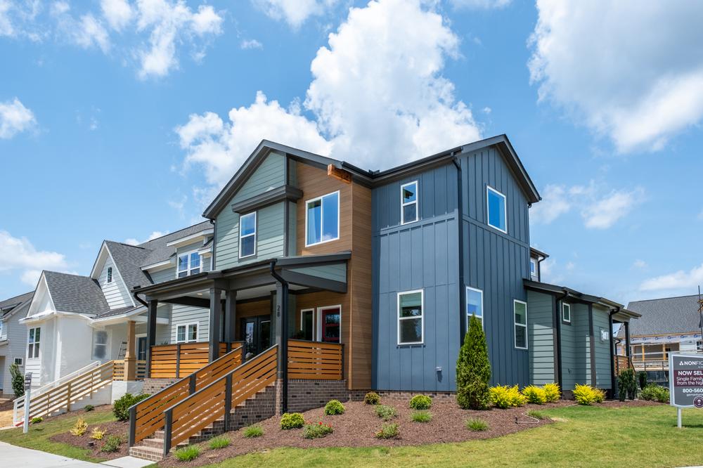 A blue, wood-toned, and dark brown home utilizing Nichiha’s fiber cement siding.