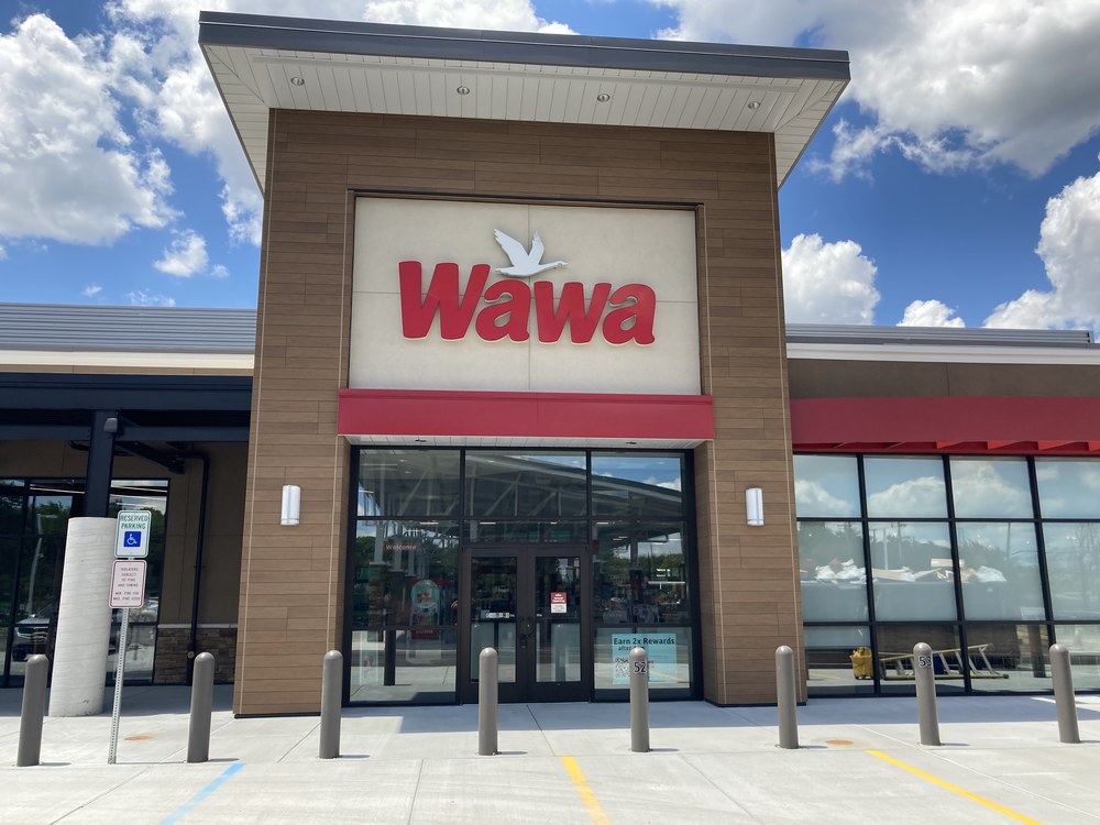 A Wawa store, with a sign in red with a white bird flying above it, is protected with Nichiha’s Vintagewood cladding.