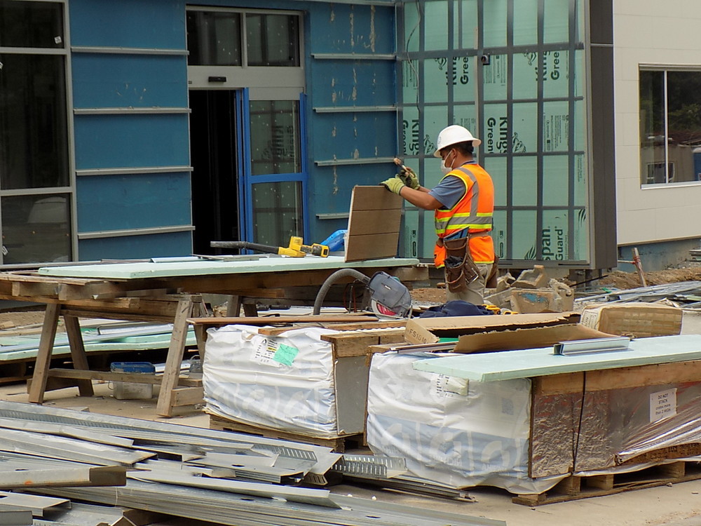 A person on a construction site handling Nichiha panels.