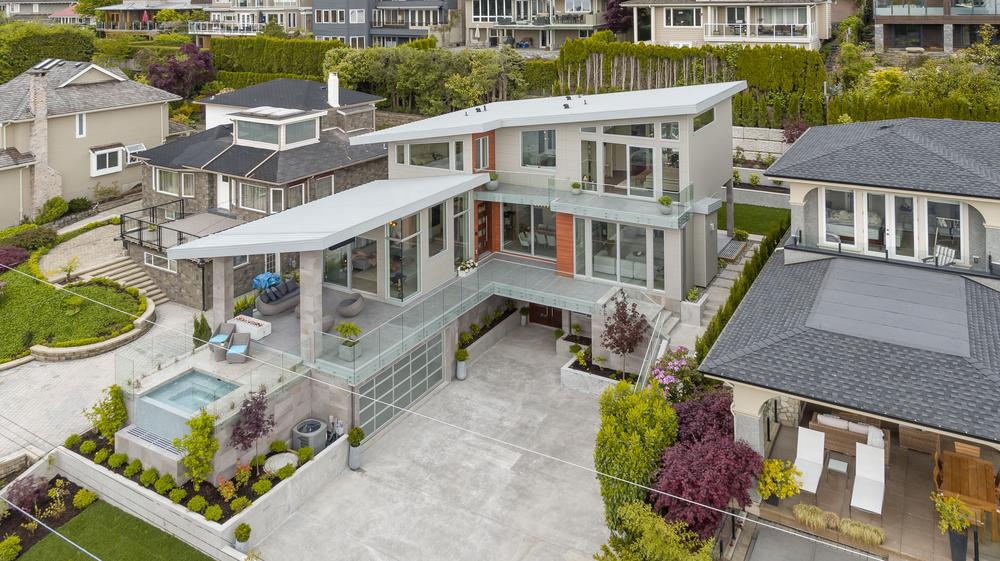 A house with Nichiha fiber cement siding and large amounts of glass windows.