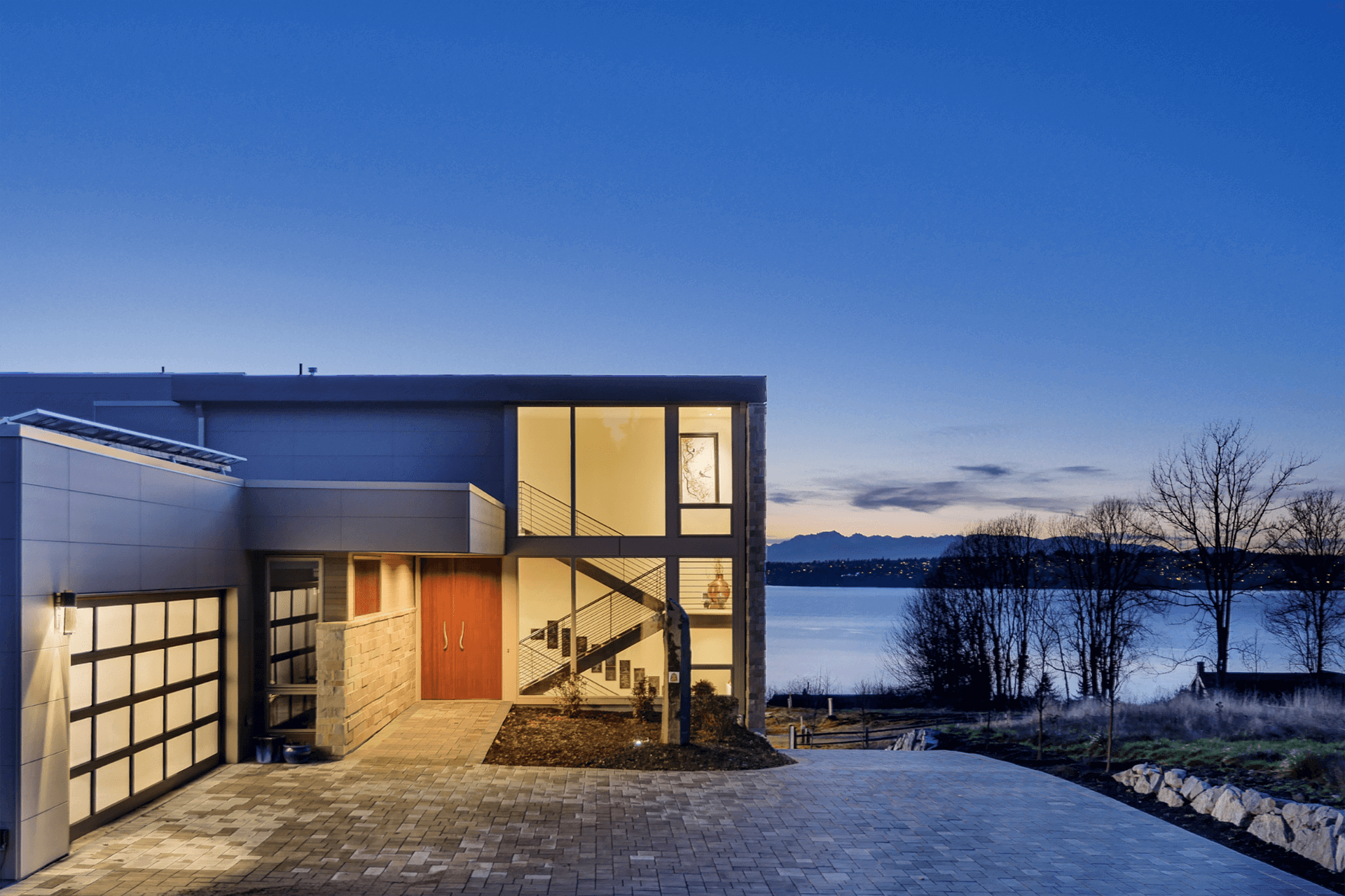 Stunning modern house at dusk with fiber cement siding