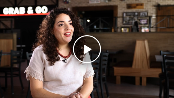 woman sitting down talking to camera